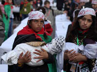 Palestinian women and children take part in a gathering to show solidarity with Palestinian refugees in Syria's main refugee camp Yarmuk, in...