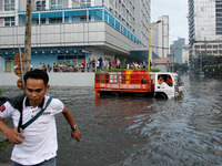 Makati, Philippines - A delivery truck wades though flood in Makati City on October 7, 2014. Strong rains causing floods hampered transporta...