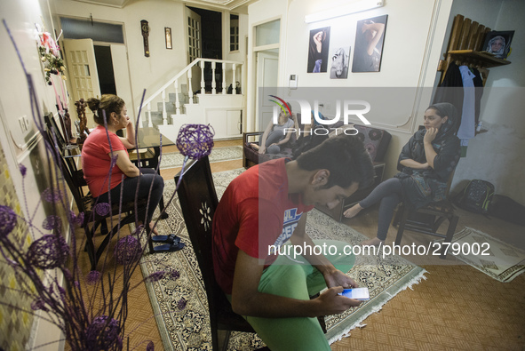 Parsa, science student, tries to access mobile Internet, while her aunt and cousin chatting with relatives, Isfahan, Iran