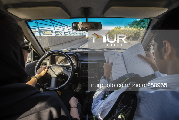 Bahor, Muslim women, drives car with his younger teenage brother Parsa, Isfahan, Iran