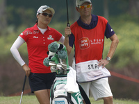 So Yeon Ryu of South Korea stands under the shading of an umbrella while waiting for her turn on the fairway of hole 10 during the second ro...