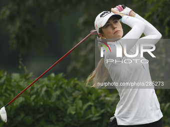 Paula Creamer of the USA watches her shot from the tee off of hole four during the third round of the LPGA Malaysia golf tournament at Kuala...