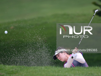 Sandra Gal of Germany clears her second shot from the bunker of hole eighteenth during the third round of the LPGA Malaysia golf tournament...