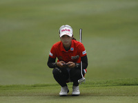 Pornanong Phatlum of Thailand lines up for a putt on the green of hole eight during the fourth round of the LPGA Malaysia golf tournament at...