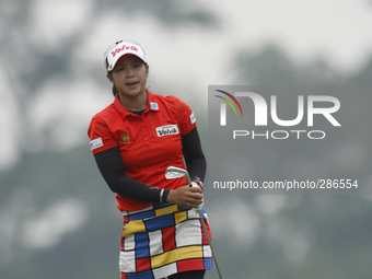 Pornanong Phatlum of Thailand reacts after playing her second shot on the hole nine during the fourth round of the LPGA Malaysia golf tourna...