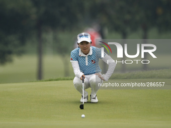 Ayaka Uehara of Japan lines up for a putt on the green of hole nine during the fourth round of the LPGA Malaysia golf tournament at Kuala Lu...