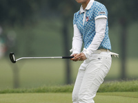Ayaka Uehara of Japan reacts after putting on the green of hole nine during the fourth round of the LPGA Malaysia golf tournament at Kuala L...
