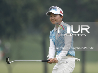 Ayaka Uehara of Japan reacts after putting on the green of hole nine during the fourth round of the LPGA Malaysia golf tournament at Kuala L...
