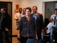 Brazil's President Dilma Rousseff, presidential candidate for re-election from the Workers Party (PT), arrives at a press conference before...
