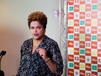 Brazil's President Dilma Rousseff, presidential candidate for re-election from the Workers Party (PT), speaks with journalists at a press co...