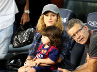 Colombian singer Shakira and her son Milan sit before the Spanish league football match FC Barcelona vs Eibar at the Camp Nou stadium in Bar...