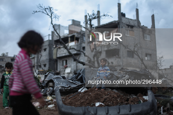 	Palestinian children play on a destroyed car in a neighbourhood damaged during the 50 day conflict between Israel and Hamas, in the Shejaiy...