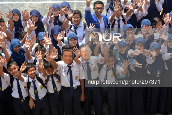 Students in Banyumas, Central Java, Indonesia, celebrate the inauguration of Indonesian President Joko Widodo, 20 October 2014. They wear fa...