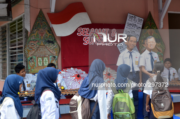 Students in Banyumas, Central Java, Indonesia, celebrate the inauguration of Indonesian President Joko Widodo, 20 October 2014. They wear fa...