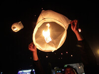 SEMARANG, INDONESIA - OCTOBER 20: Indonesians gather and release fly paper lanterns into the air as they celebrate the inauguration of new I...