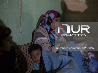 Emine and her son Walat are Kurdish-Syrians taking refuge inside a mosque in the Turkish border town of Suruc on Oct. 19, 2014. About 100,00...
