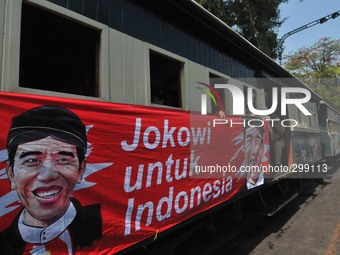 SURAKARTA, INDONESIA - October 20 : A poster of Indonesian new president Joko Widodo and his running mate, Jusuf Kalla, mounted in front of...