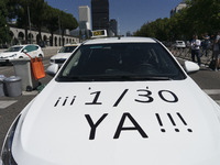 taxis block an avenue amid a strike by cabbies in Madrid on July 31, 2018. - Taxi drivers across Spain kept striking against ride-hailing co...
