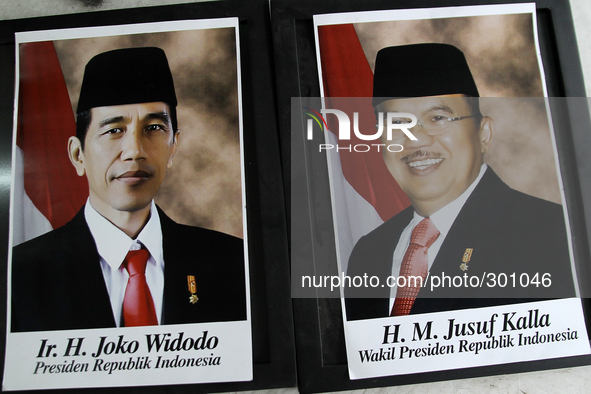 A portrait of the President of Indonesia, Joko Widodo (L) and his deputy, Jusuf Kalla (R) is immediately displayed in a shop, in Medan, Nort...