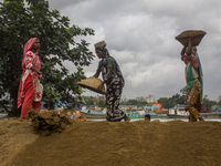 Women during the Day labors are working in a domestic port in Dhaka, Bangladesh, on 14 August 2018. (