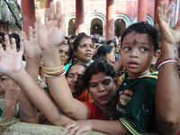 Devotees wait to get holy rice that is thrown from the top of a temple during Annakut festival. People in large numbers gather at a temple i...