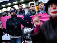 Prostitutes, some of them with her face covered with masks listen to an activist that is reading the manifesto at the end of the rally durin...