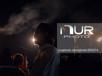 Hundreds of Muslims in Banyumas, Central Java, Indonesia, celebrate the Islamic New Year on Friday night (24/10/2014). They walk with a torc...
