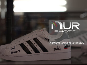 An Adidas 'Tortoise Shell' shoe sign and endorsed by Run DMC on display in a Manchester exhibition of Adidas footwear. (