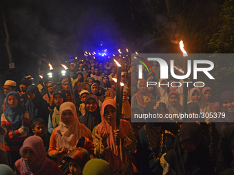 Hundreds of Muslims in Banyumas, Central Java, Indonesia, celebrate the Islamic New Year on Friday night (24/10/2014). They walk with a torc...
