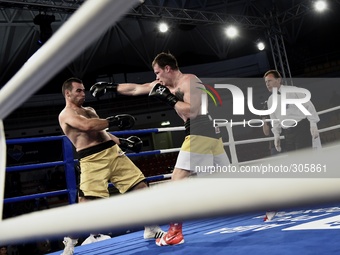 The Russian Aleksei Egorov (R) beats the Algerian Bouloudintas during Aiba matches in Rome, on October 24, 2014. (