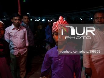 A young boy in colorful dress attended the meeting as well. (