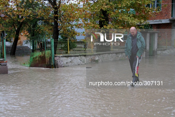 People and Civil Defence officers walk at the flooded streets in the village of Klokotnica, Saturday, Oct. 25, 2014. Bulgaria's main Black S...