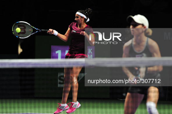 (141026) -- SINGAPORE, Oct. 26, 2014 () -- Sania Mirza (L) of India hits a return during the doubles final match of WTA Finals with Cara Bla...