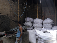 Women work in a polythene bag recycling factory in Kamrangirchar, Dhaka Bangladesh, on September 14, 2018. (