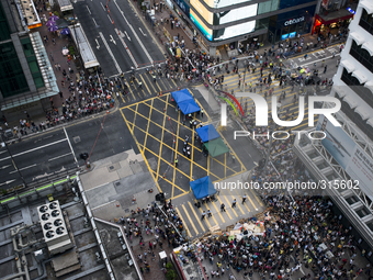 25th of October, 2015. Hong Kong, Kowloon district, Mong Kok. Occupy Central protesters stand behind a police cordon in Mong kok.  (