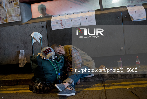 25th of October, 2015. Hong Kong, Kowloon district, Mong Kok. Pro-democracy protesters sleep next to a barricade on a occupied street at Mon...