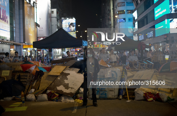 25th of October, 2015. Hong Kong, Kowloon district, Mong Kok. A pro-democracy protester guards a barricade on a street in Hong Kong.  