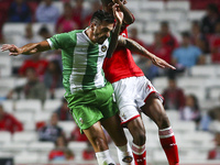 Benfica's midfielder Anderson Talisca (R) challenges Rio Ave's defender Nuno Lopes during the Portuguese League football match between SL Be...