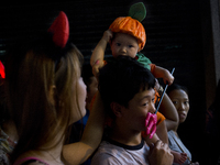 Hong Kong, Hong Kong Island, Central district. 31st of October, 2014. A family enjoys the Halloween party in Central district. (