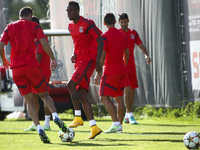 Benfica's midfielder Anderson Talisca (2nd R) takes part with team mates in a training session on the eve of the UEFA Champions League  foot...