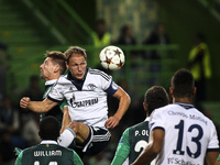 Schalke 04's defender Benedikt Howedes (2nd L) fights for the ball with Sporting's midfielder Adrien Silva during the UEFA Champions League...