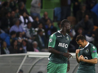 Sporting's defender Naby Sarr (L) celebrates with Sporting's defender Jefferson after scoring during the UEFA Champions League group G footb...