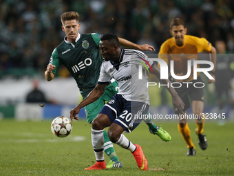 Schalke 04's forward Chinedu Obasi(R) vies for the ball with Sporting's midfielder Adrien Silva (L)  during the UEFA Champions League  group...