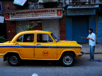 A hindu Taxi Diver Om Prakash Prasad pray her Yellow Ambassador taxis  before join her daily work at Kolkata Street  on November 07,2014. Th...