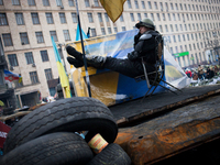 An anti protesters rest on the barricades on February 11, 2014. Russia will release the next instalment of its $15-billion loan to Ukraine a...