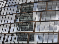 The glasswork of the Co-Operative Headquaters, on Angel's Parade in central Manchester, reflecting the CIS building. (