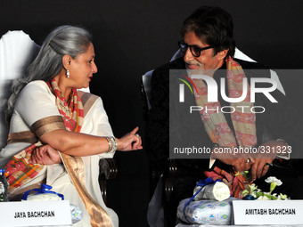 Indian film actors Amitabh Bachchan along her wife Jaya Bachchan gesture as they attend the 20th Kolkata International Film Festval at the N...
