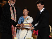 Actor Amitabh Bachhan(L), Chief Minister of West Bengal Mamata Banerjee (C), actor Shah Rukh Khan unveil the golden trophy in the opening ce...