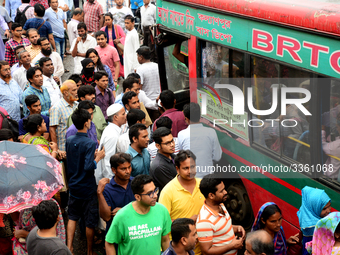 Bangladeshi Passengers gathers side the road to get on the public bus on the first day of 48-hour countrywide transport strike in Dhaka, Ban...