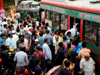 Bangladeshi Passengers gathers side the road to get on the public bus on the first day of 48-hour countrywide transport strike in Dhaka, Ban...